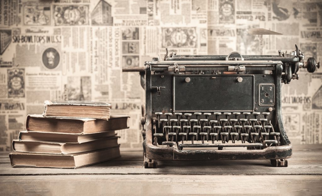 typewriter with books