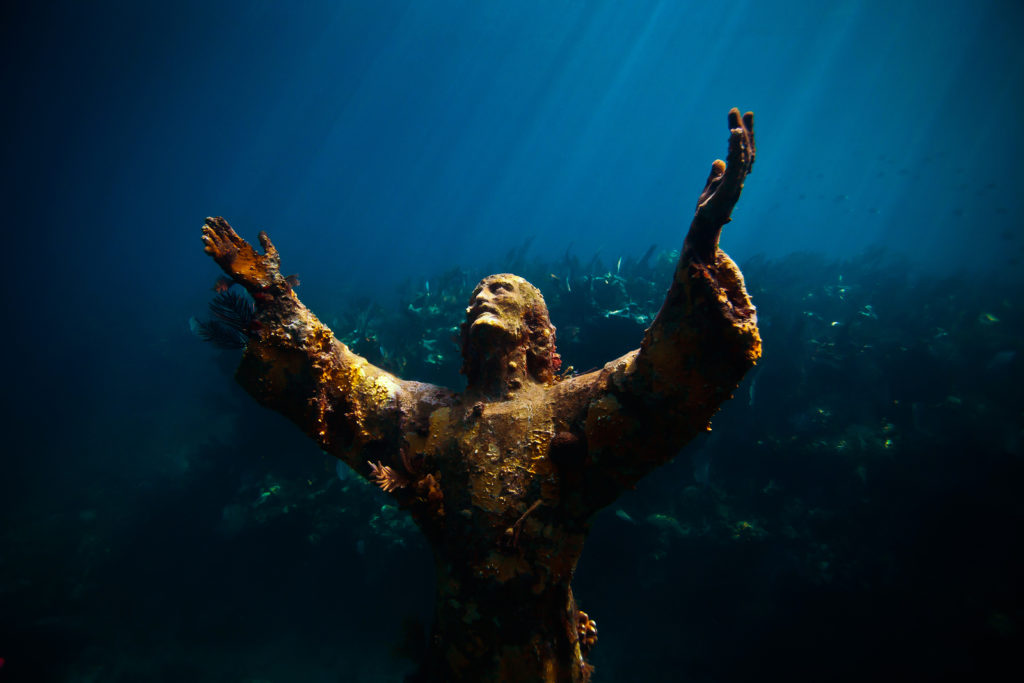 An underwater statue of Christ of the Abyss