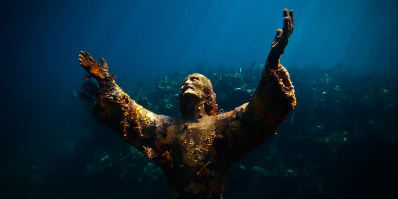 An underwater statue of Christ of the Abyss