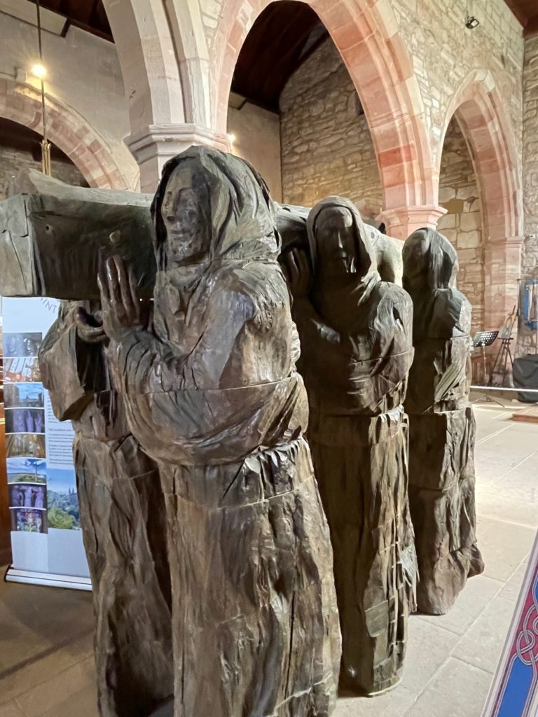 Carving of monks carrying Cuthbert's Remains at St Marys Lindisfarne Photo by JFPenn