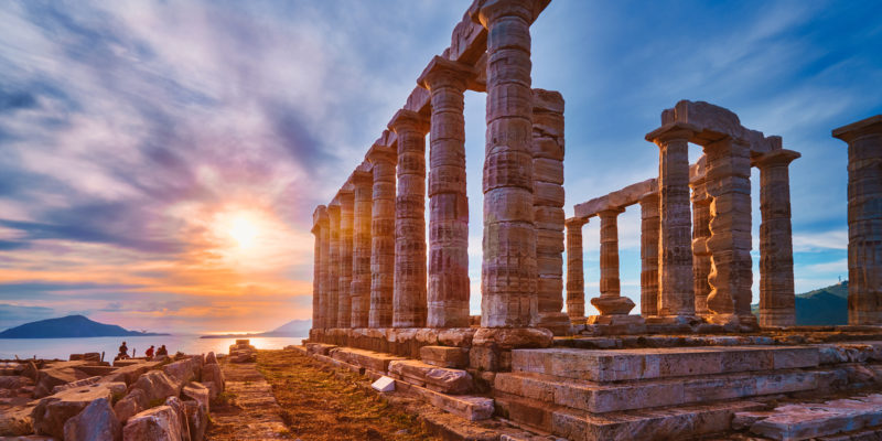 Greece Cape Sounio. Ruins of an ancient temple of Poseidon, Greek god of the sea, on sunset. Shot of temple ruins on sunset. Tourist landmark of Attica, Sounion, Greece