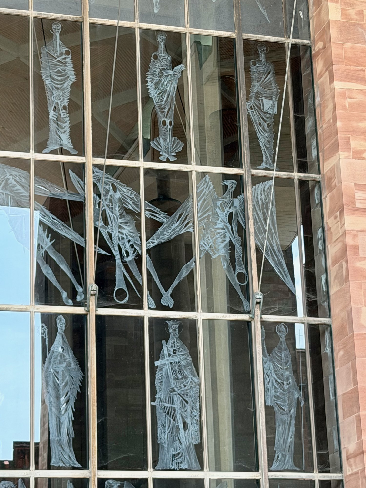 Engraved saints and angels on the West Screen, Coventry Cathedral. Photo by JFPenn