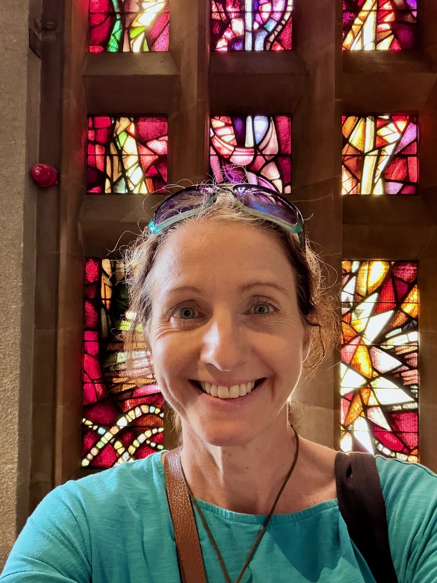Jo Frances Penn beside a nave window, Coventry Cathedral. Photo by JFPenn