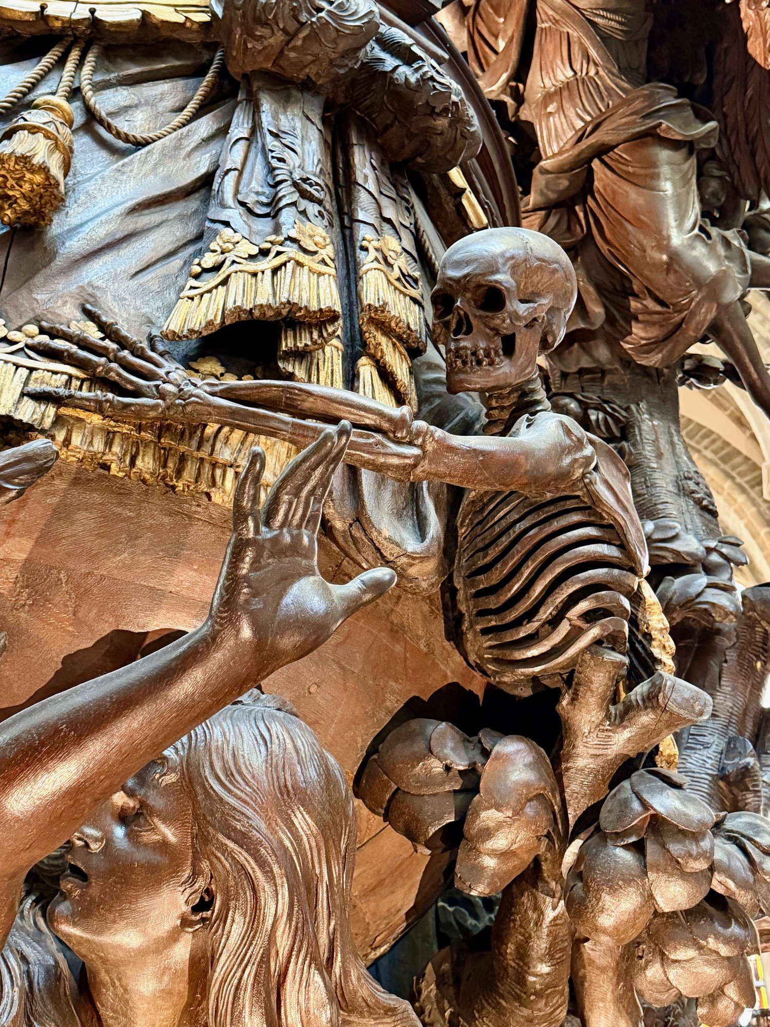 Death grasps at Adam and Eve on the pulpit, Cathedral of St Michael and St Gudula, Brussels. Photo by JFPenn