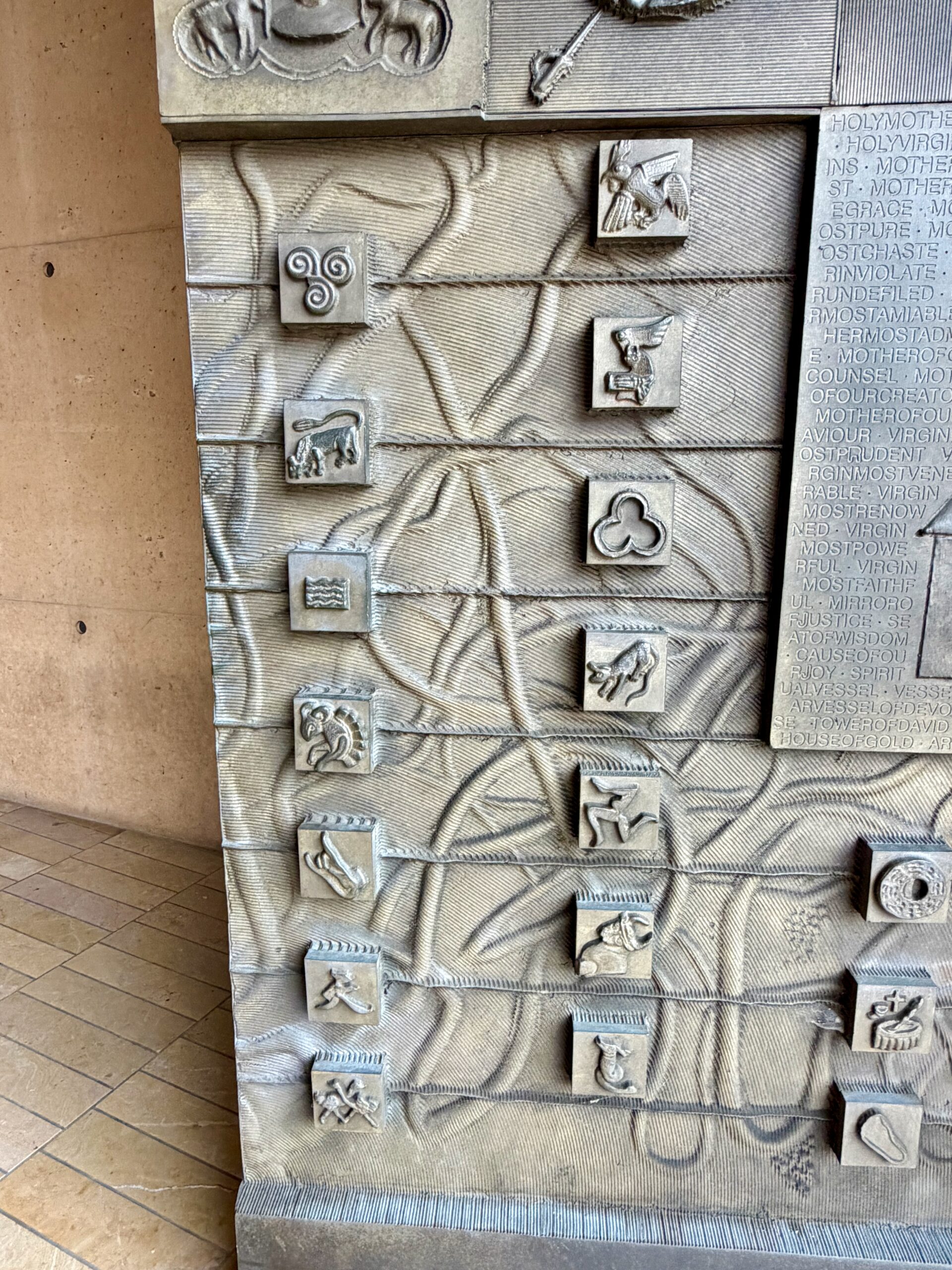 Ancient symbols on the bronze doors, Cathedral of Our Lady of the Angels. Photo by JFPenn