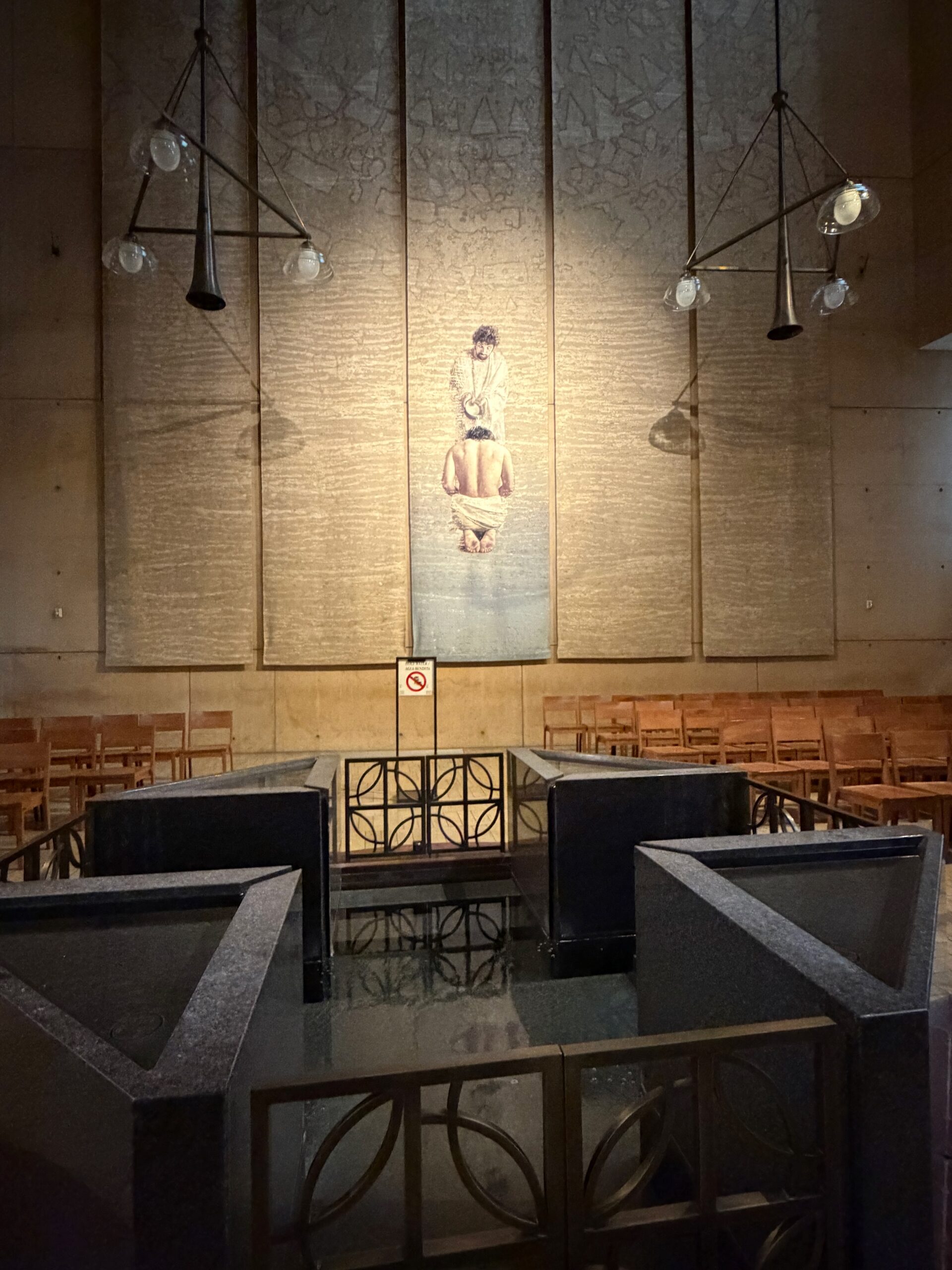 Baptismal font and the Baptism of the Lord tapestry, Cathedral of Our Lady of the Angels. Photo by JFPenn